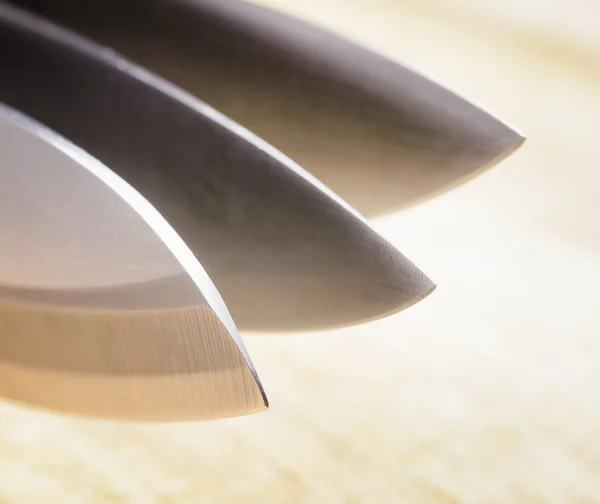 Knives on wooden board — Stock Photo, Image