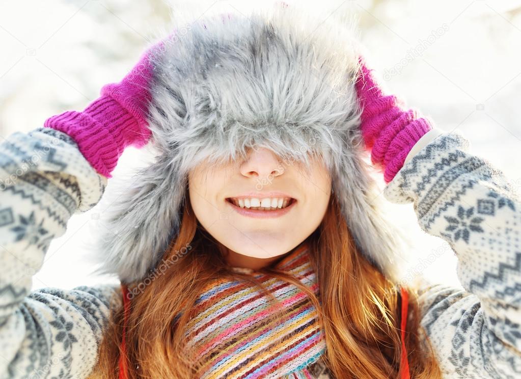 Winter portrait of young woman in fur hat