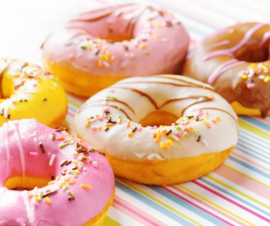 Colorful donuts on a striped napkin clipart