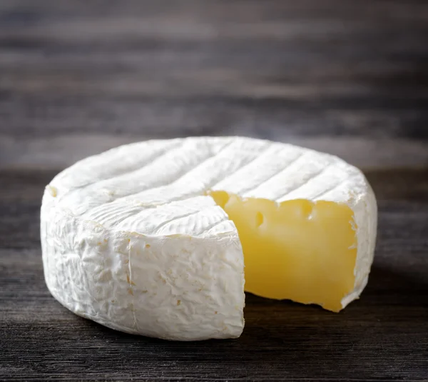Camembert cheese on a wooden board — Stock Photo, Image