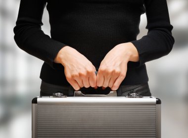 Business woman holding an aluminum briefcase and preparing for i clipart