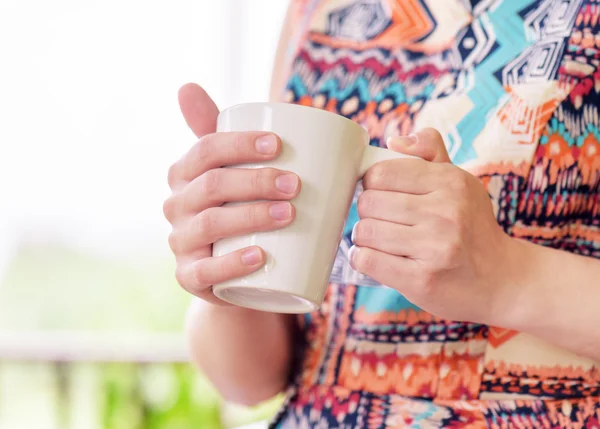 Young woman enjoying a mug of beverage. — Stock Photo, Image