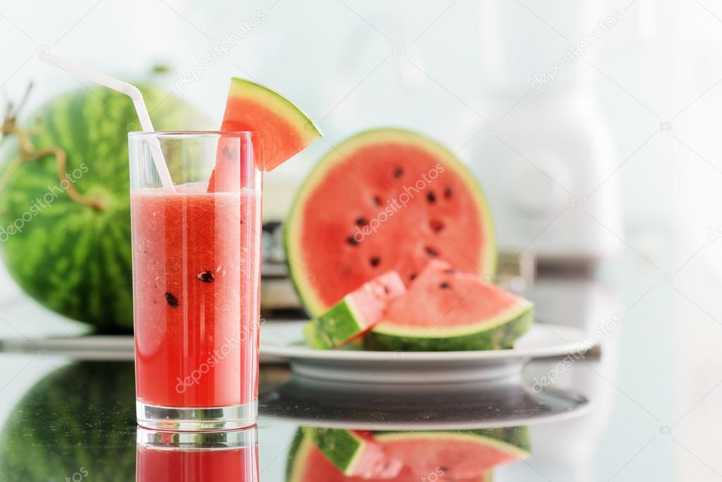 Glass of fresh watermelon juice on kitchen table