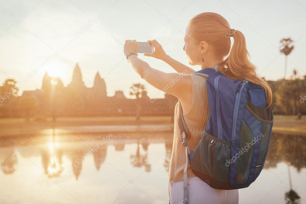 Tourist taking picture of the ancient Angkor Wat, Cambodia