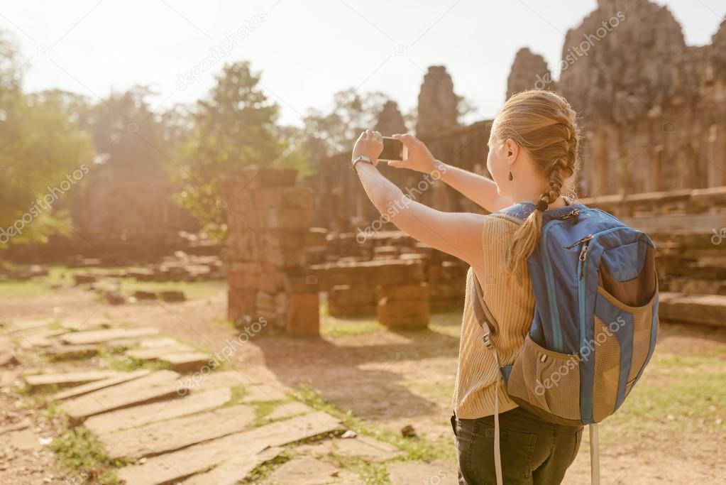Female tourist with smartphone in Angkor Thom, Cambodia