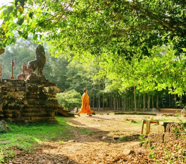 Buddhist monk coming out of Bayon temple in Angkor, Cambodia
