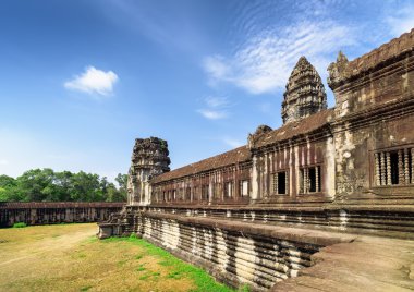 Wall of gallery and one of towers Angkor Wat temple, Cambodia