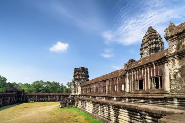 Wall of gallery and one of towers ancient Angkor Wat, Cambodia