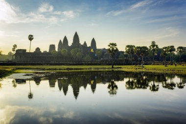 Towers of ancient Angkor Wat reflected in lake at dawn, Cambodia clipart