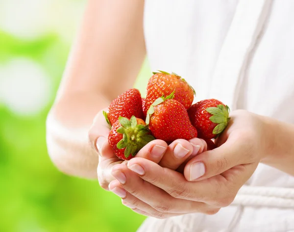 Vista de cerca de fresas frescas maduras en manos de una mujer —  Fotos de Stock