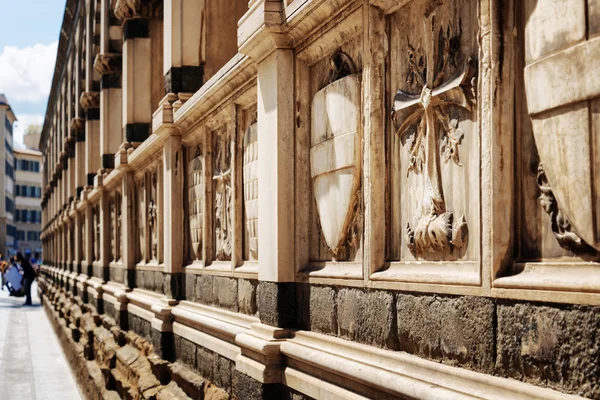 Shields and crosses on sepulchral niches in Santa Maria Novella