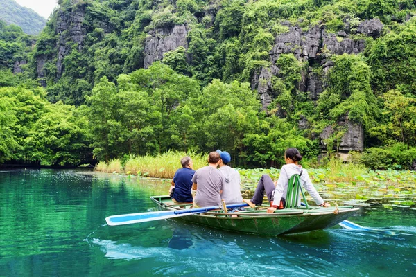 Touristes voyageant en bateau le long du fleuve Ngo Dong, Vietnam — Photo