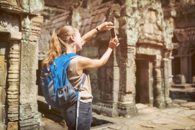 Tourist photographing the Preah Khan temple in Angkor, Cambodia