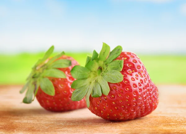 Fresh ripe sweet strawberries on wooden board — 图库照片