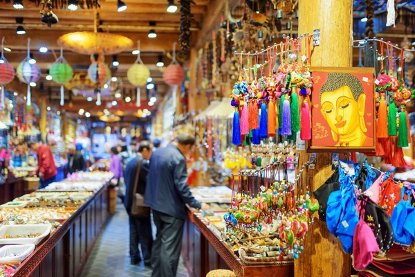 Tourists looking at souvenirs in big gift shop, Lijiang, China — Stock Photo, Image