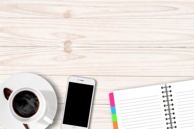 White table with coffee cup notebook and Smartphone with copy sp