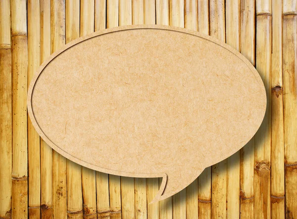 Recycle paper speech bubble on bamboo fence background — Stock Photo, Image