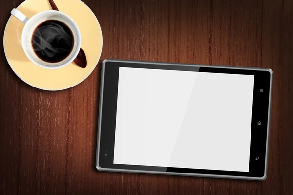 Tabletcomputer på træbord med en kop kaffe - Stock-foto