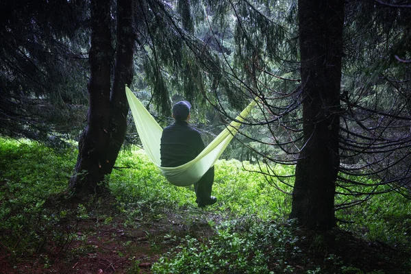 Man on yellow hammock in spring mountains — Stock Photo, Image