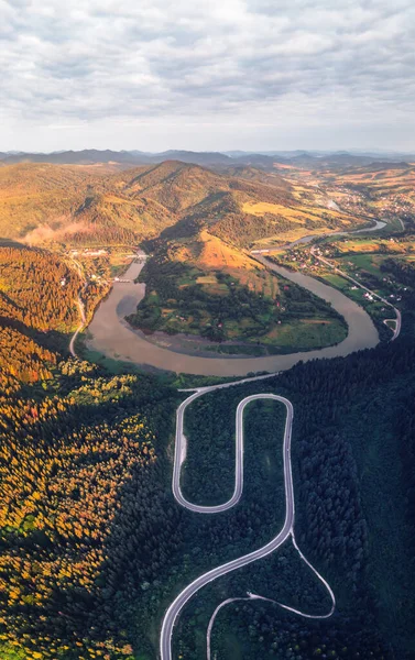 Vuelo sobre las montañas de otoño con carretera de montaña serpentina —  Fotos de Stock