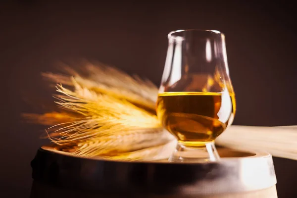 A glass of whiskey on oak barrel — Stock Photo, Image