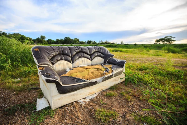Old sofa in meadow — Stock Photo, Image