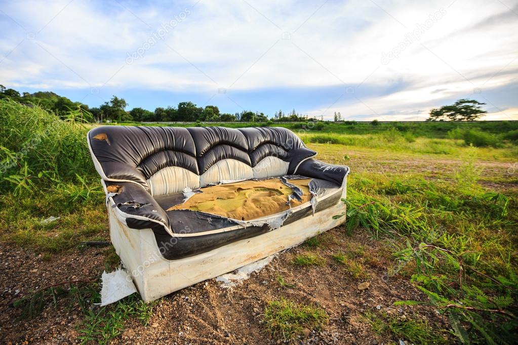 Old sofa in meadow