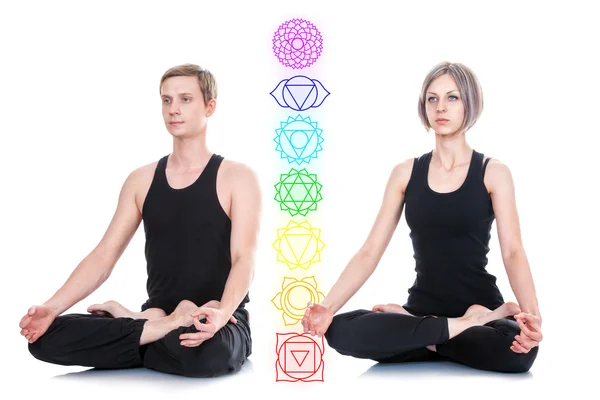 Man and woman meditating in lotus position — Stock Photo, Image