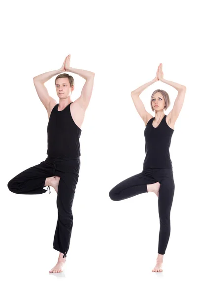 Man and woman meditating in tree position — Stock Photo, Image