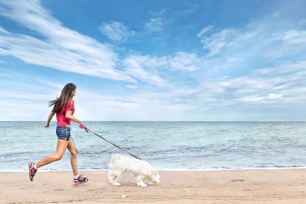 Young woman walking with dog — Stock Photo, Image