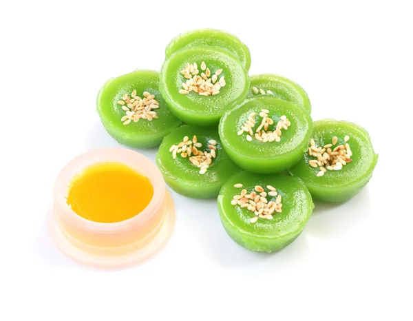 Green multiple scented sesame chinese sweet and liquid sugar on white floor.