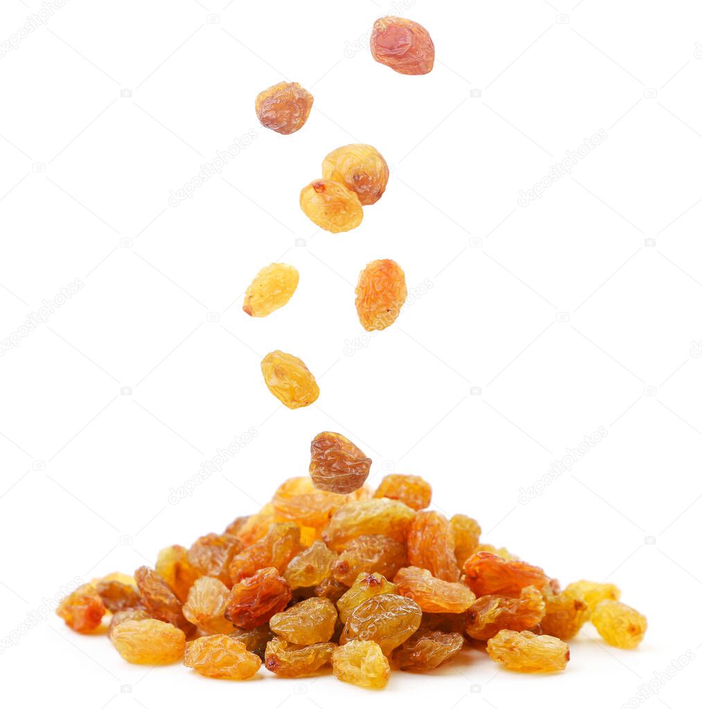 Raisins falls on a pile of close up on a white background. Isolated