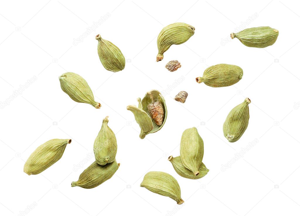 Cardamom pods whole and chopped fly on a white background. Isolated