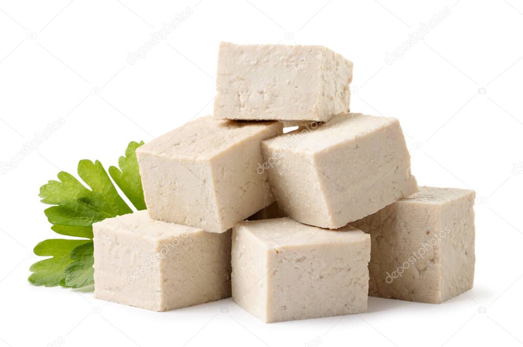 Heap of diced tofu cheese with parsley close-up on a white background. Isolated