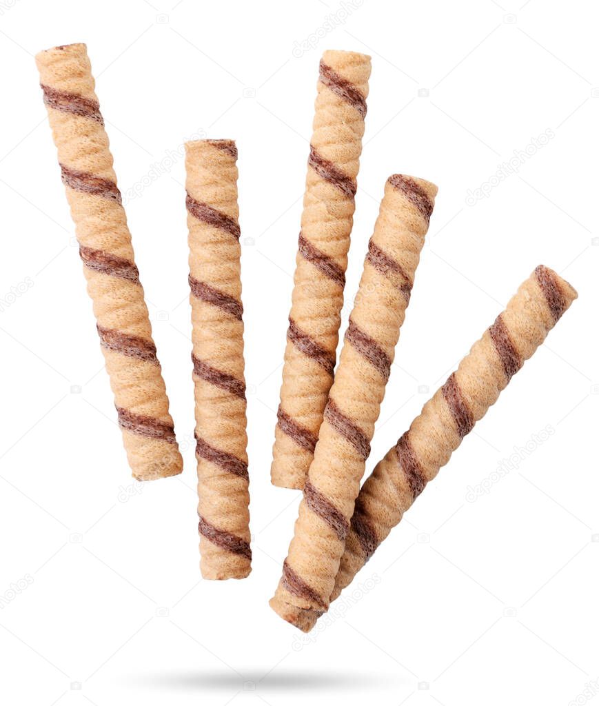 Striped wafer rolls are flying on a white background. Isolated