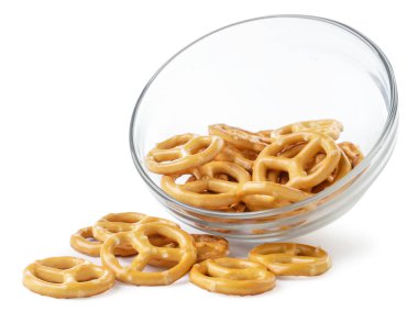 Pretzel spilling out of a plate close-up on a white background, oktoberfest. Isolated