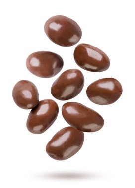 Chocolate covered peanuts flying on a white background. Isolated