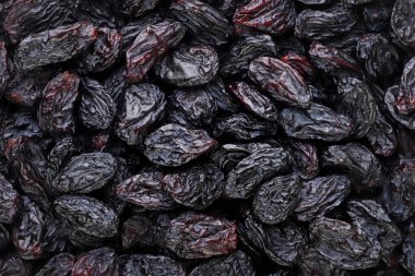 Black raisins close-up, background. Top view