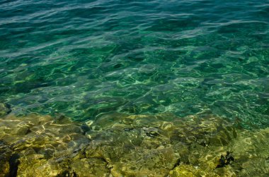 The rocky background of the sea throught emerald water, Nemira, Croatia clipart