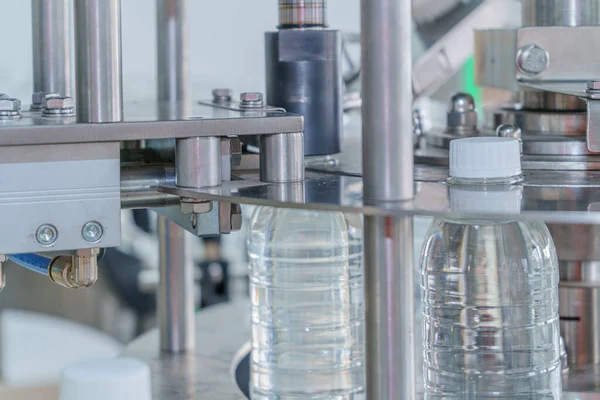 Modern industrial manufacturing factory of pouring mineral water. Selective focus.