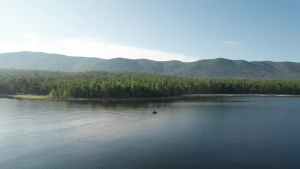 Epic vista aérea cinematográfica Lago Baikal por la mañana. Agua turquesa en un lago de bosque montañoso con pinos. Vista aérea del lago azul y bosques verdes. Vista sobre el lago entre el bosque de montaña. — Vídeos de Stock