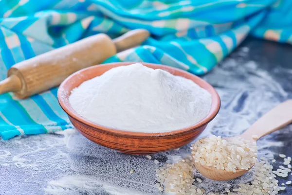 Rice flour and raw rise in spoon — Stock Photo, Image