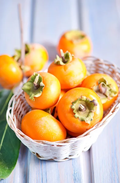 Ripe persimmons in basket — Stock Photo, Image