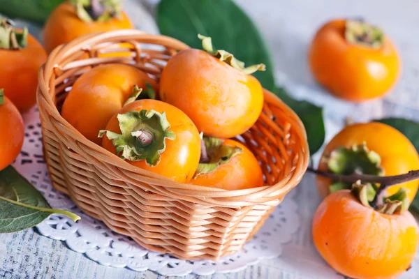 Ripe persimmons in basket — Stock Photo, Image