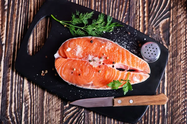 Raw salmon on slate — Stock Photo, Image