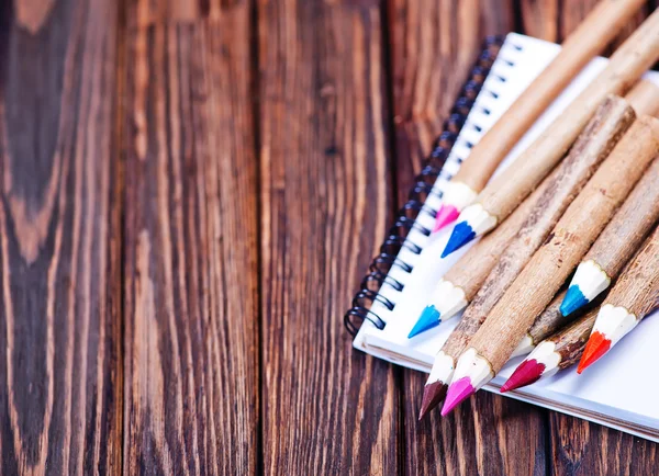 Multicolored pencils on notebook — Stock Photo, Image