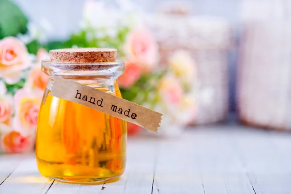 Rose oil in glass bottle — Stock Photo, Image