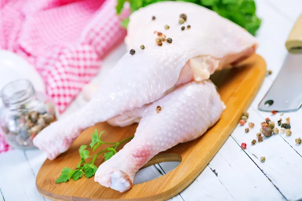 Chicken legs on cutting board — Stock Photo, Image
