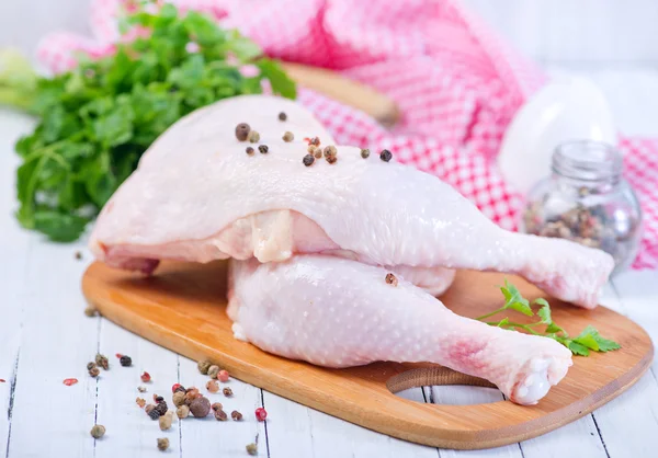 Chicken legs on cutting board — Stock Photo, Image