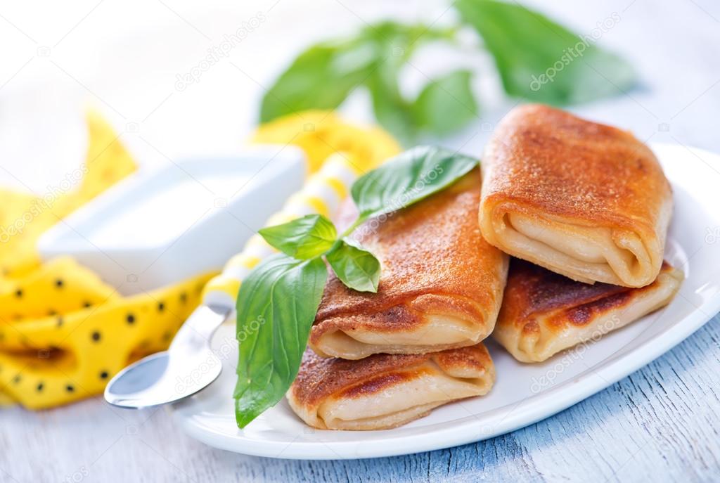 pancakes with meat and basil leaves